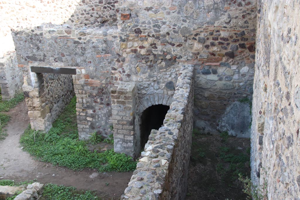 HGW24 Pompeii. Villa of Diomedes. October 2023.
Looking east towards doorway to room 7,7, arched entrance, and east end of passageway 6,b. Photo courtesy of Klaus Heese.