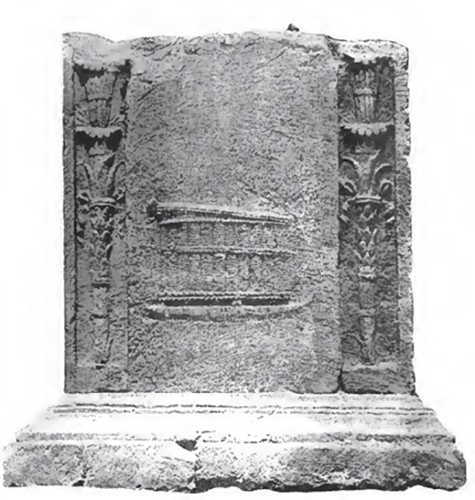 NGH Pompeii. 1910 photo of south side of altar on Schola tomb.
According to Spano, this is a mystical chest, made of rushes, cylindrical, wide, and supported by feet, of which three are visible.
The head of a snake is lifting the cover. This side is framed by two great torches.
This symbolises that the buried person had been in initiated in life into the mysteries of Dionysus.
See Notizie degli Scavi di Antichità, 1910, p. 395-6.