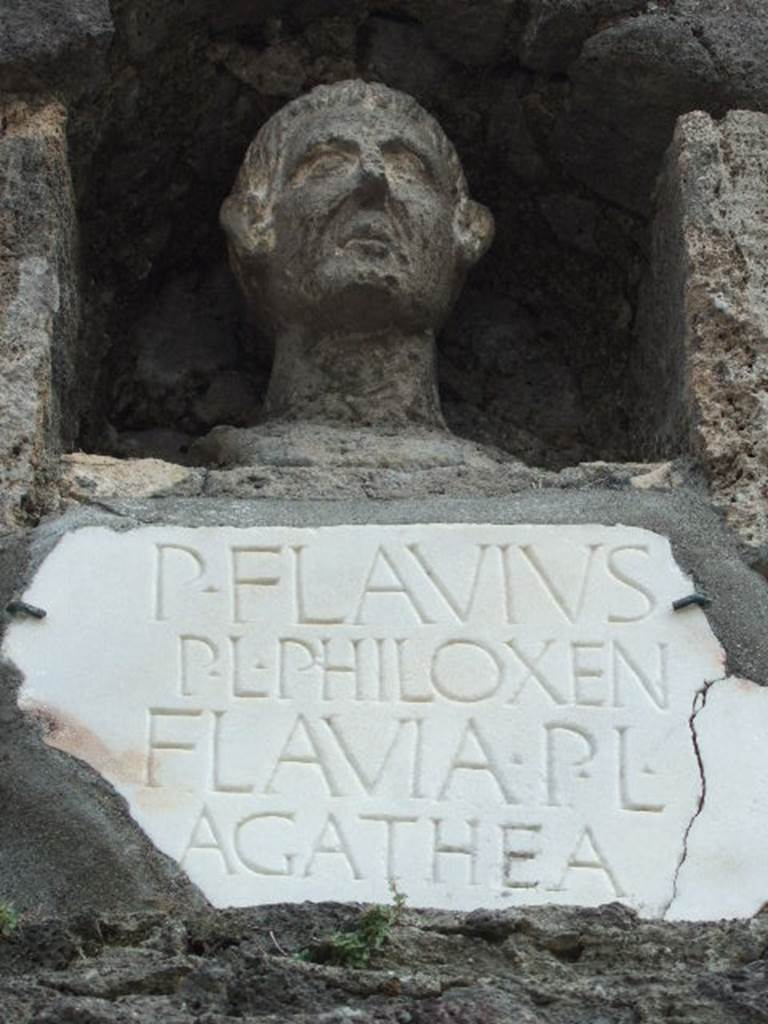 Pompeii Porta Nocera Tomb 7OS. May 2006. Bust and marble plaque with inscription.
P(ublius) FLAVIVS
P(ubli) L(ibertus) PHILOXEN(us)
FLAVIA P(ubli) L(iberta)
AGATHEA.