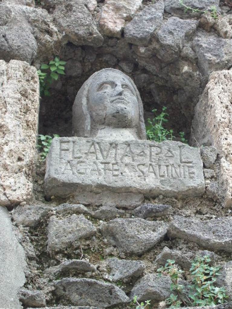 Pompeii Porta Nocera. May 2006. Tomb 7OS. Bust of a woman with inscription on base.
FLAVIA P(ubli) L(iberta)
AGAT(h)EA SALINIE(nsis)
Flavia Agathea was “from the saline area”.
Saliniensis would seem to refer to the stretch of coast between Torre Annunziata and Castellamare.
See D’Ambrosio, A. and De Caro, S., 1983. Un Impegno per Pompei: Fotopiano e documentazione della Necropoli di Porta Nocera. Milano: Touring Club Italiano. (7OS)
