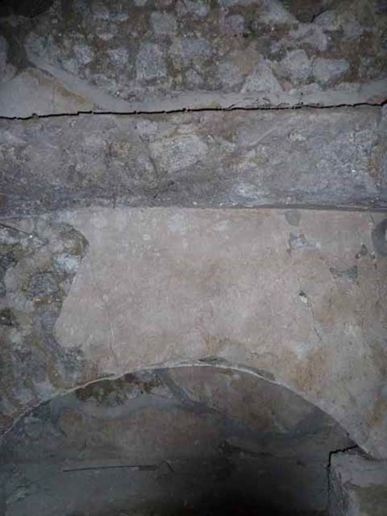 Pompeii Porta Nocera. May 2010. Tomb 7OS. Large niche on east wall of room on east of entrance corridor.
There are two identical rooms on each side of the corridor.
On the floor of this room were found the skeletons of three dogs.
Also found was a fragment of a marble tablet decorated with a relief of a male figure seated on a stool in the act of handing a scroll to a child.
The relevance of this to the tomb is unknown.
See D’Ambrosio, A. and De Caro, S., 1983. Un Impegno per Pompei: Fotopiano e documentazione della Necropoli di Porta Nocera. Milano: Touring Club Italiano. (7OS)