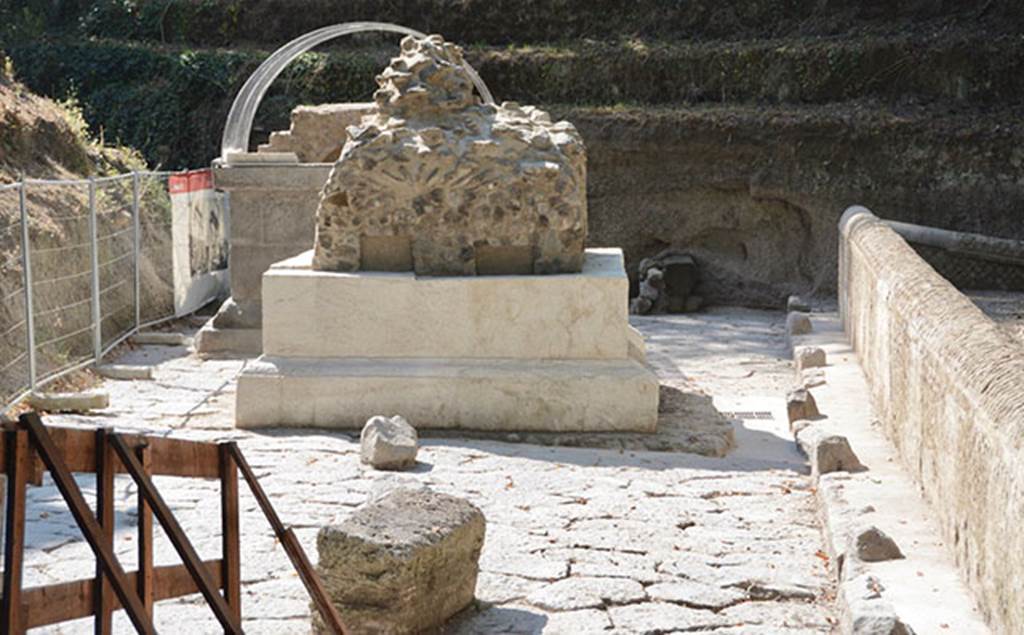 SG4 and SG5 Pompeii. 2018. Tomb SG4 is at the front with SG5 behind
These are two chamber tombs excavated in 2001 and located in an area bound by a pavement and a small plaster coated opus reticulatum wall.
Unusually the tombs appear to be placed in the middle of the road.
The road paving was entirely covered in a thick layer of alluvial deposits.
The removal of this deposit layer revealed an unfinished sub-square masonry structure to the south of Tomb SG4.
These likely relate to a third tomb, which was unfinished following the abandonment of the site, as the tuff and lava blocks which were discovered in the immediate vicinity and appeared ready to be used in construction would indicate, along with a pile of lava and small block chips.
See http://pompeiisites.org/en/comunicati/the-tombs-of-the-necropolis-of-porta-stabia/