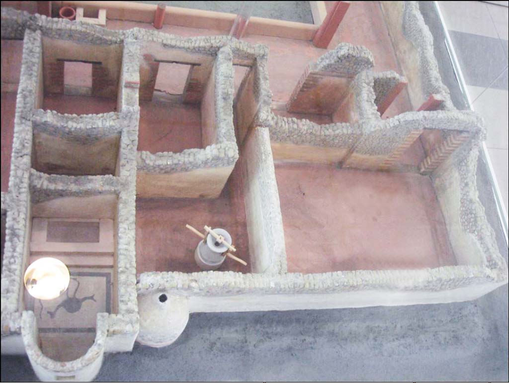 Villa della Pisanella, Boscoreale. The three rooms in the corner are cubiculum “D” (left rear), porters room “B” (right rear) and the large room “C” which was under the road at the time of excavation.
Centre is the room at the end of corridor “E” with grain mill and bread oven with triclinium “F” behind.
Left are calidarium “O” with mosaic floor, boiler room “L” and cubiculum “G”. Model of villa in Boscoreale Antiquarium.