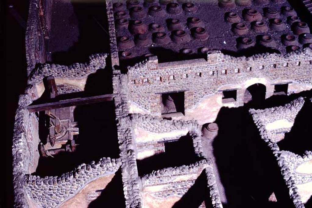 Villa della Pisanella, Boscoreale. 1972. Photograph from model of Villa, room T, the olive press room can be seen in the centre-left.
Room S, the corridor that contained the vessels for the oil can be seen in the centre-right, with arched doorway leading to room Q, cella vinaria.
Photo by Stanley A. Jashemski.
Source: The Wilhelmina and Stanley A. Jashemski archive in the University of Maryland Library, Special Collections (See collection page) and made available under the Creative Commons Attribution-Non-Commercial License v.4. See Licence and use details.
J72f0514