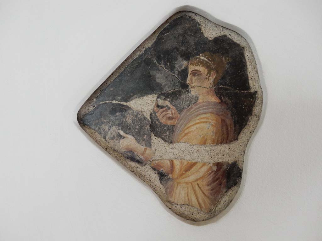 Villa della Pisanella, Boscoreale. May 2018. Upper floor. Black ground fresco with a female figure feeding two apples to a child or animal.
Photo courtesy of Buzz Ferebee.