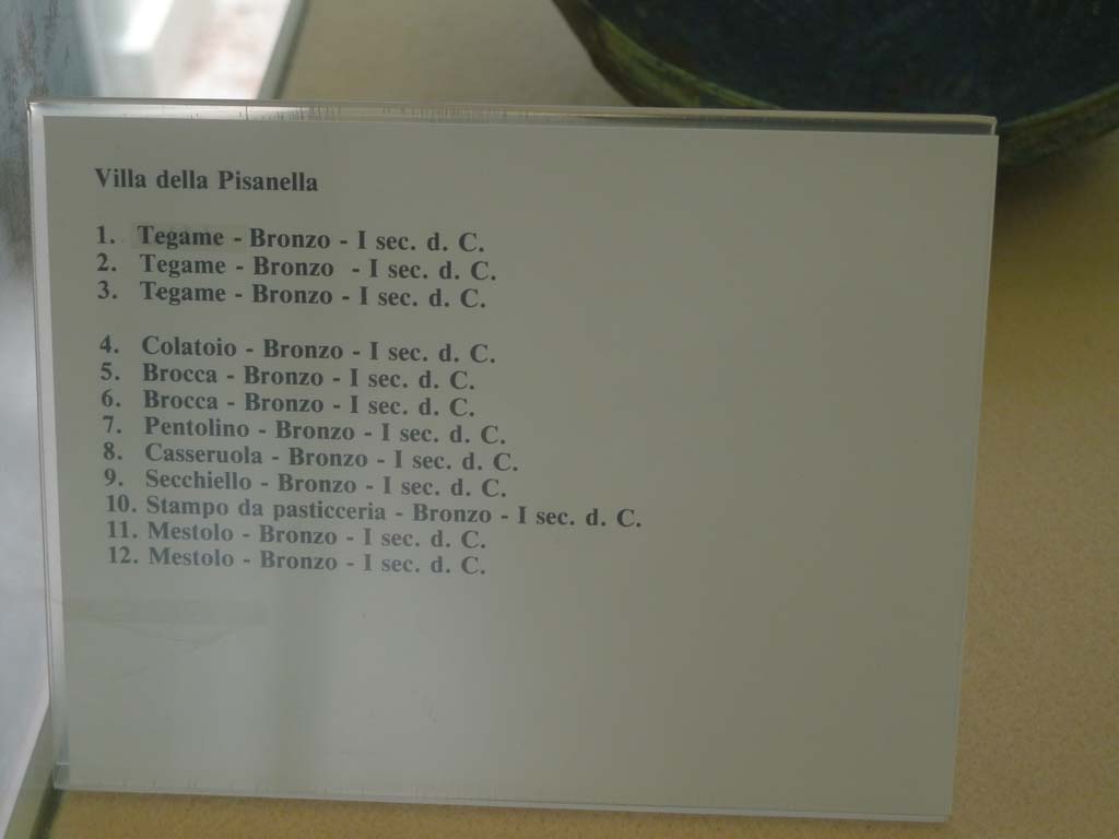 Villa della Pisanella, Boscoreale. July 2010. Information card from Boscoreale Antiquarium giving detail of 12 bronze items found in the villa.
Photo courtesy of Michael Binns.