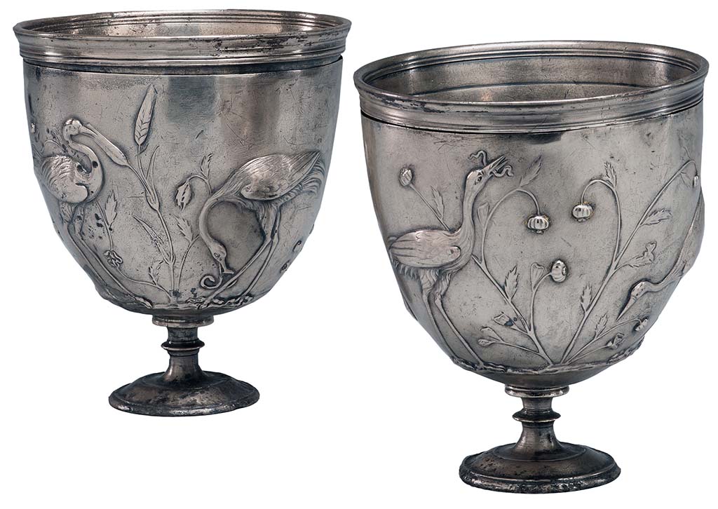 Villa della Pisanella, Boscoreale. Pair of silver cups with cranes in relief.
According to the Morgan Library, each cup consists of an inner liner and an outer casing, which is worked in repoussé.
The original silver gilt has largely worn away, and the double handles are missing.
There are guide marks for placing of handles in Greek letters.
The decoration consists of cranes feeding among wheat or sorghum, hunting snakes, a lizard, butterflies, and a grasshopper.
On one side of one cup, the birds stand beside poppies.
Although the cups were found in Rome, the are believed to be the work of a Greek craftsman.
Probably from the Villa Maxima (=Villa Pisanella) at Boscoreale.
See https://www.themorgan.org/objects/item/161025
Now in The Morgan Library and Museum, New York. Purchased by J.P. Morgan, inventory number AZ050-1 and AZ050-2.
