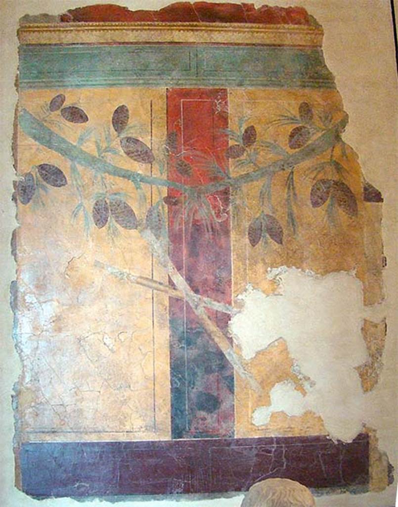 Villa of P Fannius Synistor at Boscoreale. Room D. The room of the musical instruments. According to Sambon, the wall panels had pine branches to which were attached musical instruments. He lists flutes, cymbals, crotales (small pair of cymbals), a syrinx (pan pipes), etc. This panel is from the centre of a wall. It was the only one conserved. Two yellow panels are separated by a red stripe. A garland is composed of two pine branches laden with cones, and from the centre of which are suspended two crossed flutes. The panel is 1.80m high by 1.26m wide. Now in the Louvre. Inventory Number P100.