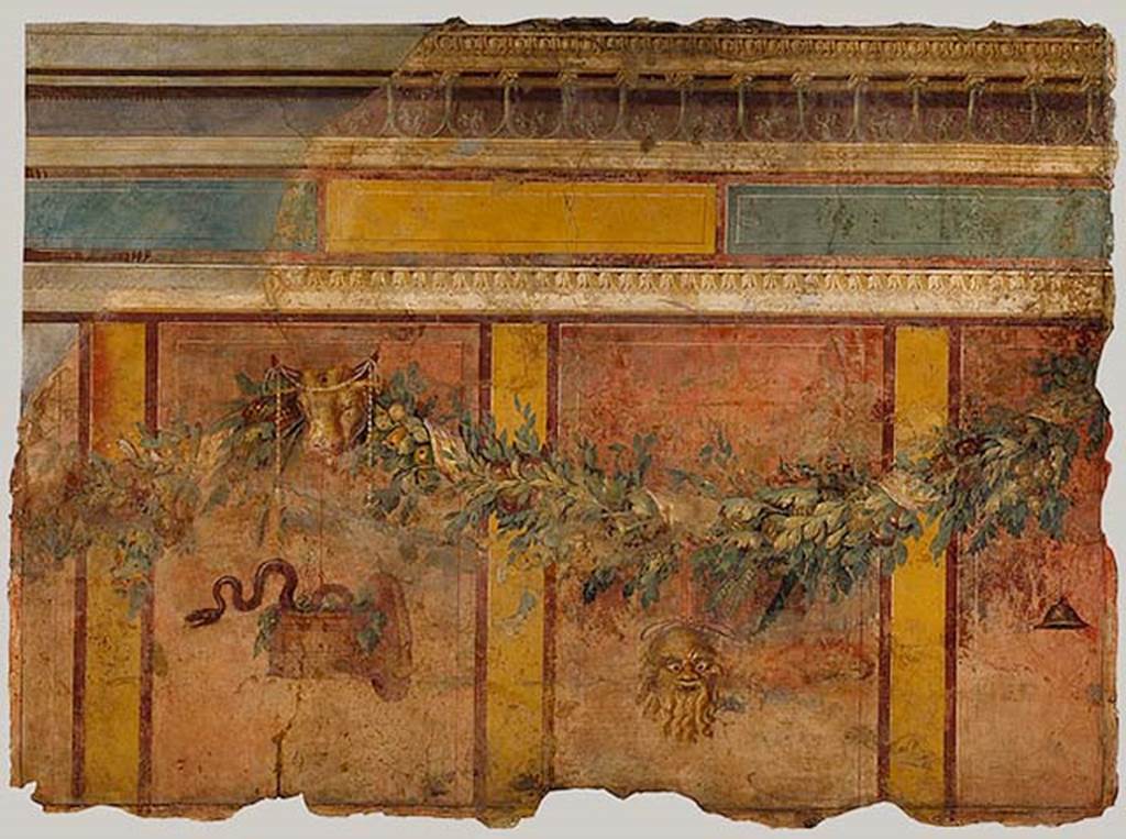 Villa of P Fannius Synistor at Boscoreale. Room L exedra/tablinum, west wall.
Garland with Silenus mask, sacred basket, and bucrania (ceremonial bulls heads).
These are all references to the god Dionysus.
According to Barnabei, above a dark zoccolo (plinth), a metre tall, finished at the top with a white strip, large red cinnabar panels ran up the wall.
The panels were one metre and twenty centimetres tall, and eighty centimetres wide.
These red panels were separated by yellow stripes, about fifteen centimetres wide.
The red panels were surrounded by a narrow band of brown.
See Barnabei F., 1901. La villa pompeiana di P. Fannio Sinistore. Roma: Accademia dei Lincei. p. 39-46.
Photo © The Metropolitan Museum of Art, Rogers Fund 1903. Inventory number 03.14.4.
See www.metmuseum.org