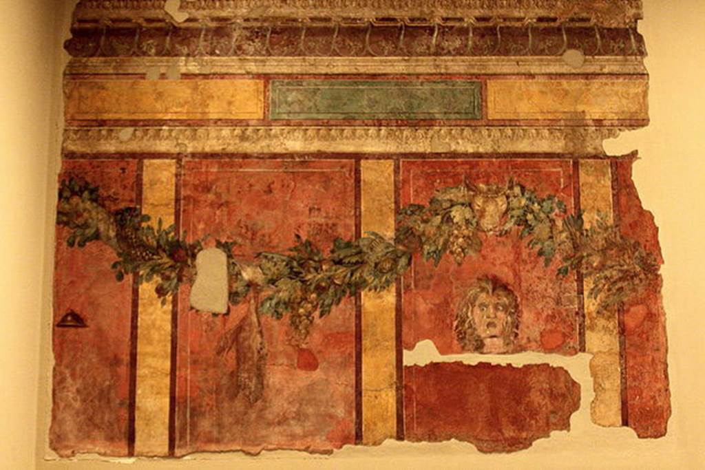 Villa of P. Fannius Synistor at Boscoreale. Room L, tablinum, rear wall.
Garlands are supported by a ceremonial bulls head.
A satyr mask is in right hand panel which would have been the centre of the wall.
In the panel to the left of the mask a dead hare is suspended from the garland.
In the panel to the far left is a small cymbal (cymbalum).
Photo courtesy of Michel Wal, Wikimedia Commons.
This photo is subject to an Attribution-ShareAlike 3.0 Unported licence.
Now in the Musée Royal de Mariemont, Morlanwelz, Belgium. Inventory number R61.
http://www.musee-mariemont.be/