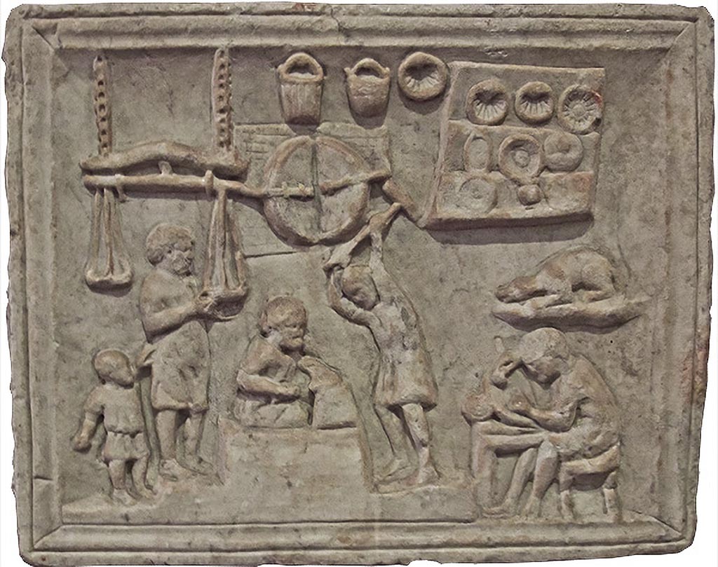 Pompeii, location not known. Relief of a metalworkers workshop. Photo courtesy of Barbara McManus.
Now in Naples Archaeological Museum. Inventory number 6575.
According to Barbara McManus, this was probably a shop sign, depicting several stages in the process of making metal utensils. On the left, the metal is weighed in large hanging scales (note the child holding on to the man's tunic); in the top centre is depicted the furnace, below which a smith hammers the hot metal on an anvil. On the right, an artisan sculpts a utensil, while finished buckets, seashell shapes for the making of cakes, and plates are displayed above him.
According to Appleton, a marble relief from Pompeii in the Naples Museum (inv. 6575) depicts a coppersmith at work surrounded by pastry-moulds, dishes, plates, and buckets.
See Appleton, G., 1987. Animal Sculpture from Roman Gardens Buried by Vesuvius, (PhD thesis, Newcastle University, UK), p. 224 and note 7.