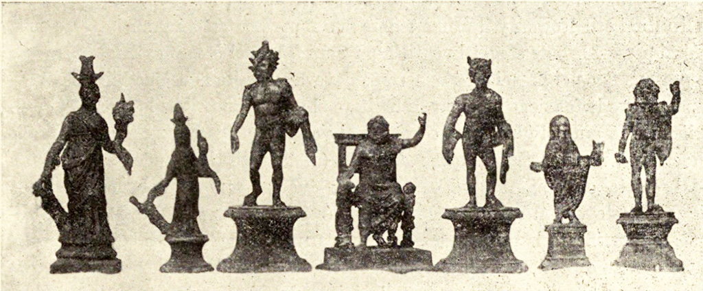 Boscoreale, La villa del Fondo Acunzo. 1903. Room 12. Podium “y”.
Group of seven bronze statuettes found on podium built against the east wall of the room which opened off the kitchen 8:
Centre: Jupiter seated
To the left: Helios with radiant crown
Furthest left: Two figures of differing sizes representing Isis-Fortuna
To the right of Jupiter: Mercury or a young nude faun with pan pipes
Further right: Genius familiaris wearing a toga
Right hand end: Standing Jupiter or Neptune with arm raised
See Notizie degli Scavi di Antichità, 1921, p. 440-1, fig.11.
See Boyce G. K., 1937. Corpus of the Lararia of Pompeii. Rome: MAAR 14. (p.100, no.500B).