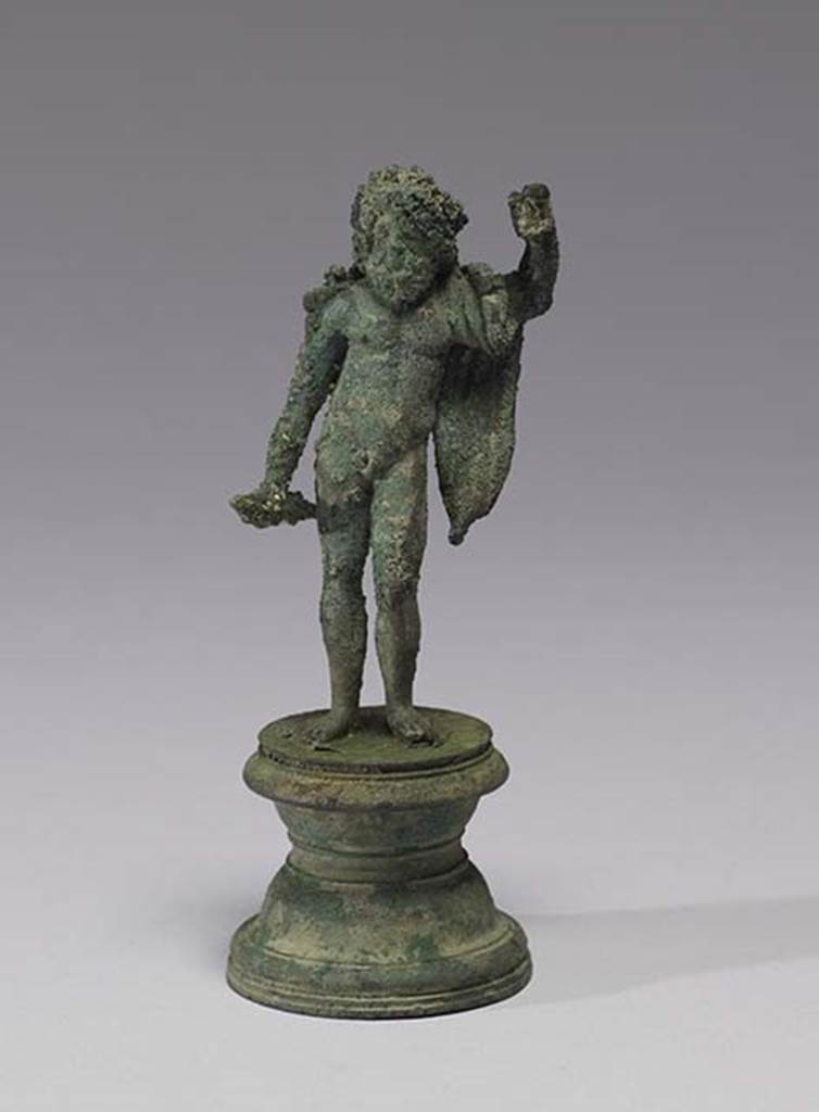 Boscoreale, Villa rustica in fondo D’Acunzo.Room 12, lararium.
Bronze statuette of standing Jupiter, 0.10m high, front view.
According to Della Corte, the statue depicted Neptune, bearded, nude except for a mantle over his left shoulder.
In his right was possibly a dolphin, the left was raised like that of Jupiter, as if supported upon a sceptre or trident, now missing.
Both attributes, perhaps, were made of wood.
See Notizie degli Scavi di Antichità, 1921, p. 440.
According to Stefani, the different. and more plausible interpretation proposed by others is an image of Jupiter.
See Stefani G., 2000. In Sylva Mala, Bollettino del Centro Studi Archeologici di Boscoreale, Boscotrecase e Trecase XII, p. 15 and note 44.
Photo courtesy of The Walters Art Museum, Baltimore. Inventory number 54.749.
http://thewalters.org/
Creative Commons Attribution-ShareAlike 3.0 Unported Licence