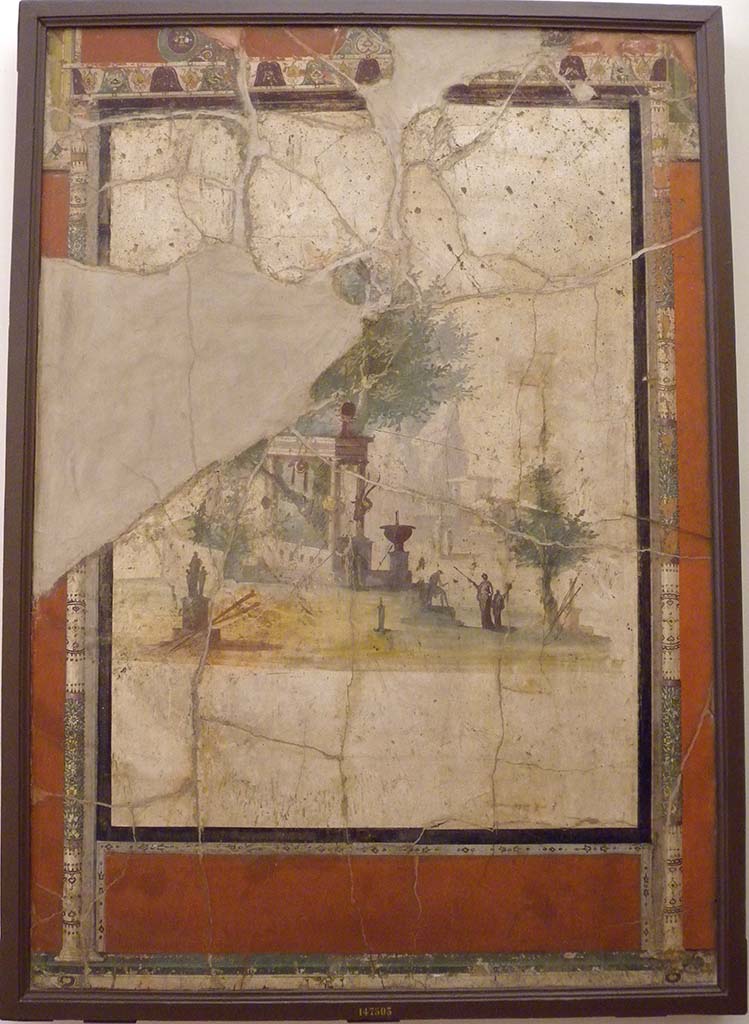 Villa Agrippa Postumus. Boscotrecase. Room 16, west wall.
The west wall had at its centre a white ground panel depicting an architectural landscape of Alexandrian style with statues, fountains and travellers in front of a shrine overshadowed by a leafy tree.
Now in Naples Archaeological Museum. Inventory number 147503.