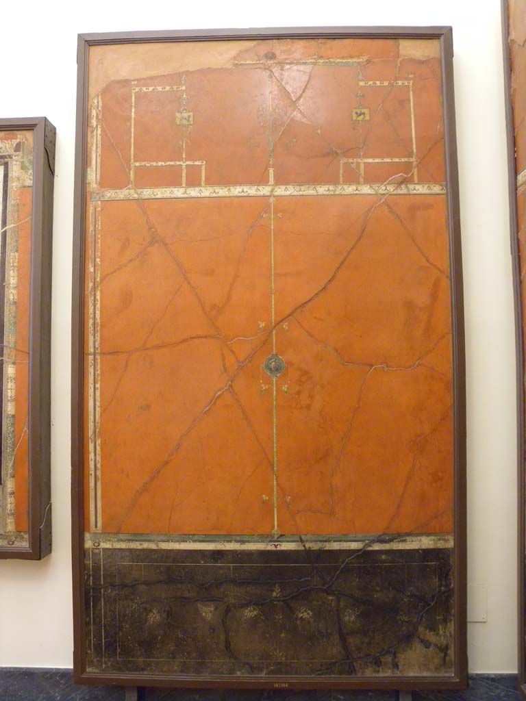 Villa Agrippa Postumus. Boscotrecase. Room 16, west wall.
The ante-room wall is dominated by small panels crossed by a particularly slender candelabrum motif with branches.
This continues up into the higher part of the wall where it is flanked by symmetrical architectural elements.
Now in Naples Archaeological Museum. Inventory number 147504.