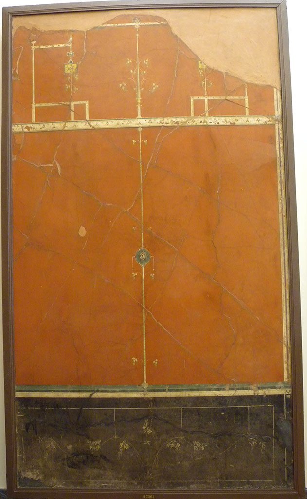 Villa Agrippa Postumus. Boscotrecase.Room 16, east wall.
Now in Naples Archaeological Museum. Inventory number 147505.
On the right-hand wall the decorative scheme of the left-hand wall was repeated with duplication of decorative details such as the elegant branches of the dado/plinth, suspended from the cornice of the panels by delicate ribbons.