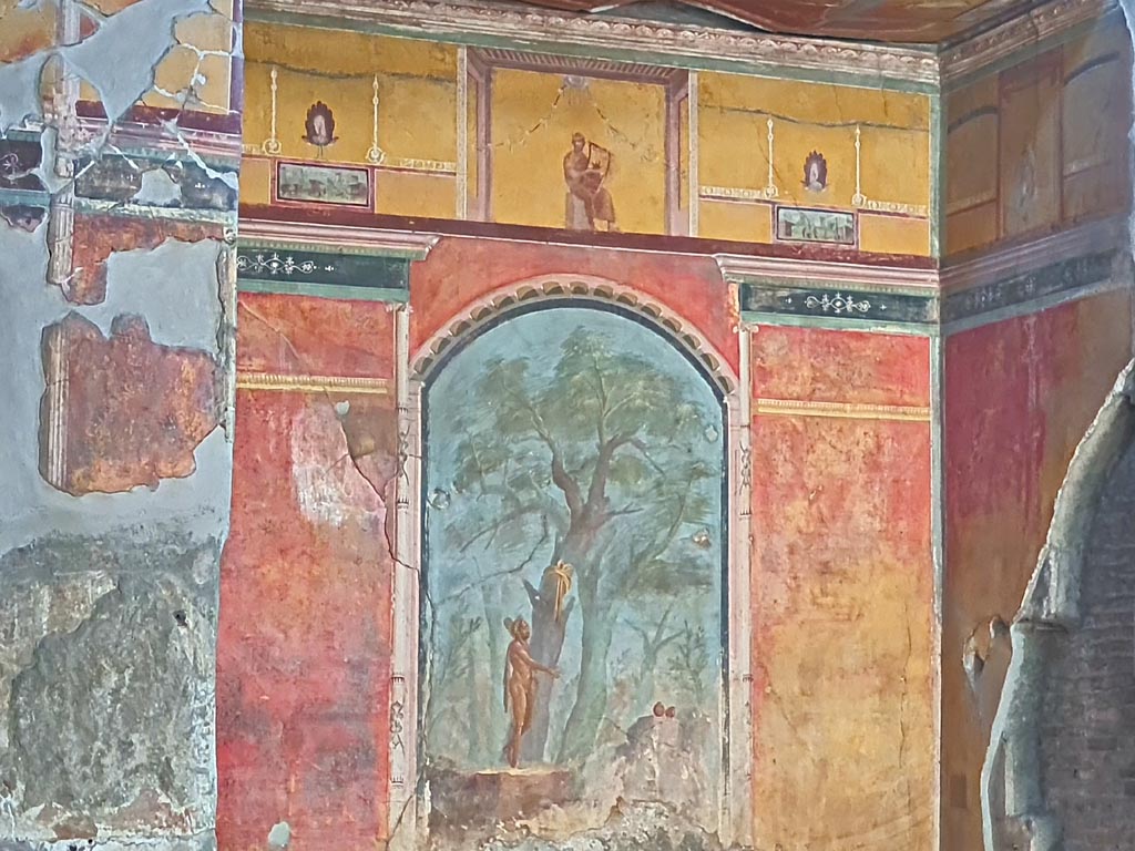Oplontis Villa of Poppea, October 2023. Room 8, painted upper east wall in recess.
In the centre is a painting of a poet playing the lyre. On either side of him are painted peacocks.
Below them are painted panels of scenes and landscapes taken from daily life. Photo courtesy of Giuseppe Ciaramella.