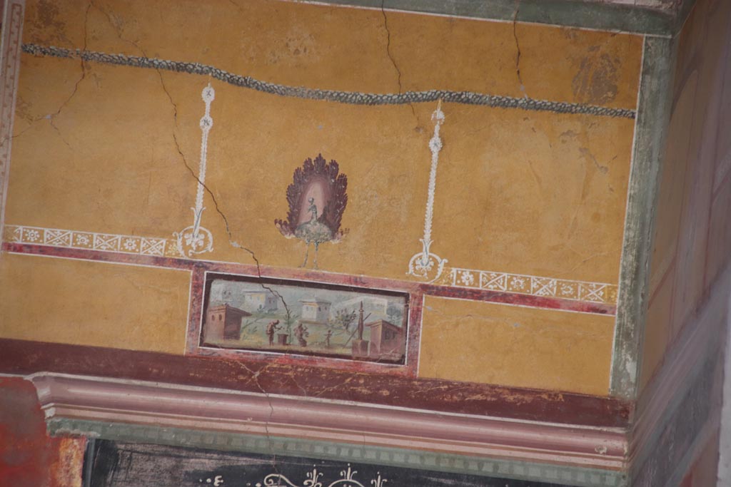 Oplontis Villa of Poppea, October 2022. Room 8, painted upper east wall at south end of recess.
Beneath the painted peacock is a panel which maybe shows a man making a sacrifice on an altar, watched by a woman and a boy.
Photo courtesy of Klaus Heese.