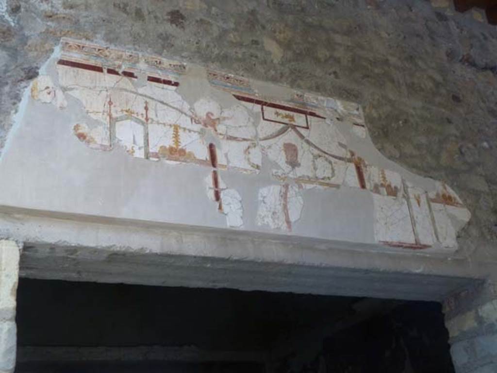 Oplontis, May 2011. Room 23, detail of painted decoration above doorway in portico 24. Photo courtesy of Michael Binns.