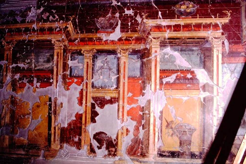 Oplontis, 1974. Room 23, at the top of the wall is a still-life of a glass bowl of pomegranates, and below it is a painted basket of fruit covered with a veil.
Photo by Stanley A. Jashemski.
Source: The Wilhelmina and Stanley A. Jashemski archive in the University of Maryland Library, Special Collections (See collection page) and made available under the Creative Commons Attribution-Non Commercial License v.4. See Licence and use details. J74f0649