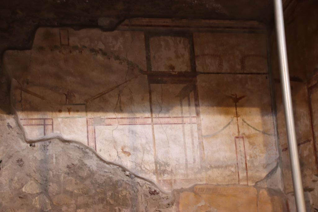 Oplontis Villa of Poppea, May 2024. Room 27, painted decoration from west wall, behind lararium. Photo courtesy of Klaus Heese.