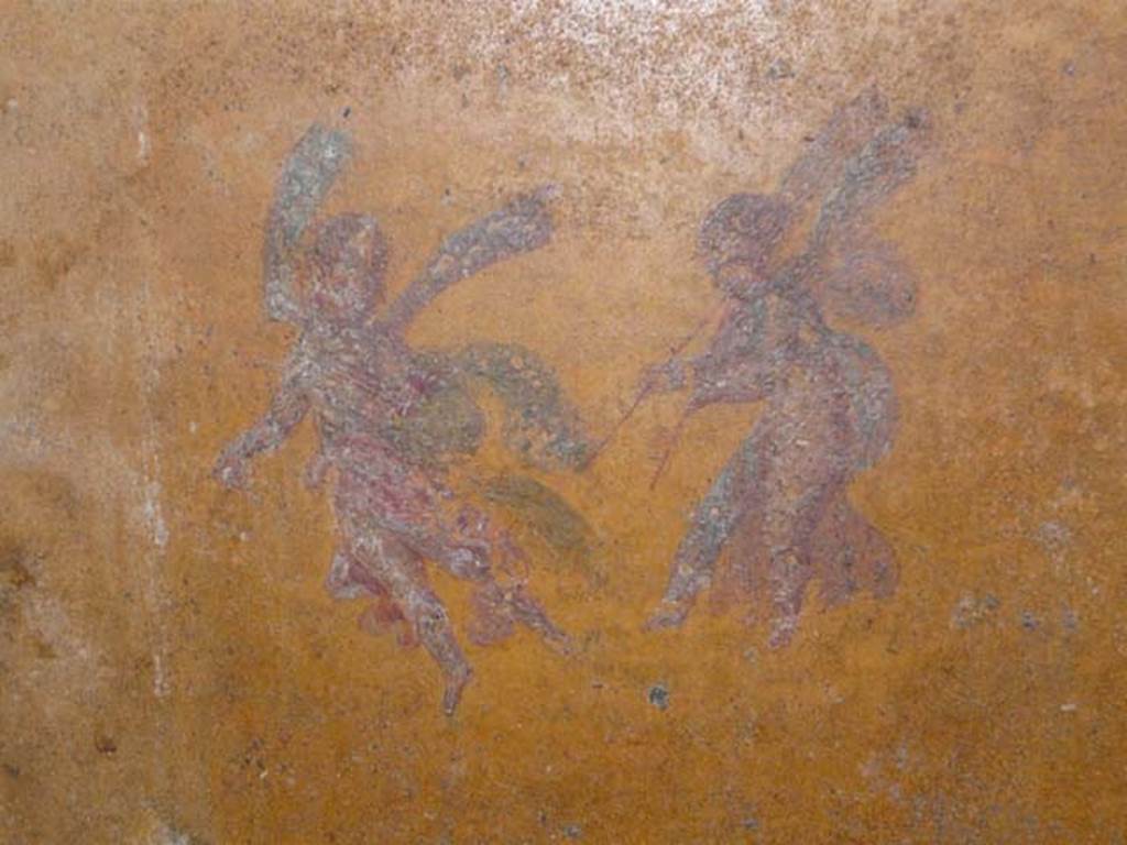 Oplontis Villa of Poppea, May 2011. Room 31, north wall, west end. Painting of two flying cupids, one playing a double flute.
Photo courtesy of Buzz Ferebee.