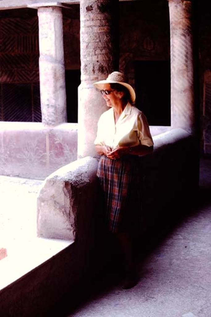 Oplontis, 1974. Room 32, Wilhelmina in the rustic peristyle. Looking south-east, the interior wall of the pluteus (low wall) can be seen painted with plants. Photo by Stanley A. Jashemski.
Source: The Wilhelmina and Stanley A. Jashemski archive in the University of Maryland Library, Special Collections (See collection page) and made available under the Creative Commons Attribution-Non Commercial License v.4. See Licence and use details. J74f0621