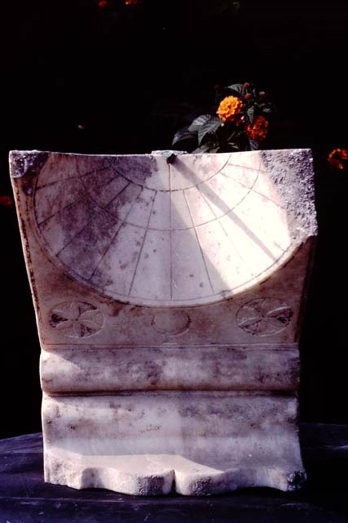 Oplontis, c.1974-77. Room 32. Sundial.
Source: The Wilhelmina and Stanley A. Jashemski archive in the University of Maryland Library, Special Collections (See collection page) and made available under the Creative Commons Attribution-Non Commercial License v.4. See Licence and use details. Oplo0008
According to Wilhelmina –
“Against the east side of the fountain we found the cavity left by a large tree. The two carbonized chestnuts found in the lapilli in the south-east corner of the garden, at the height of the ceiling beams, probably fell from a branch of this tree. The sundial in the north-east corner had no doubt become useless as the large tree shaded the garden”.
See Jashemski, W. F., 1993. The Gardens of Pompeii, Volume II: Appendices. New York: Caratzas. (p.294)