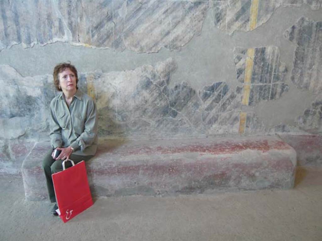 Oplontis, May 2011. Corridor 46, detail of bench near south wall, including a “sitting” tourist for scale. Photo courtesy of Buzz Ferebee.