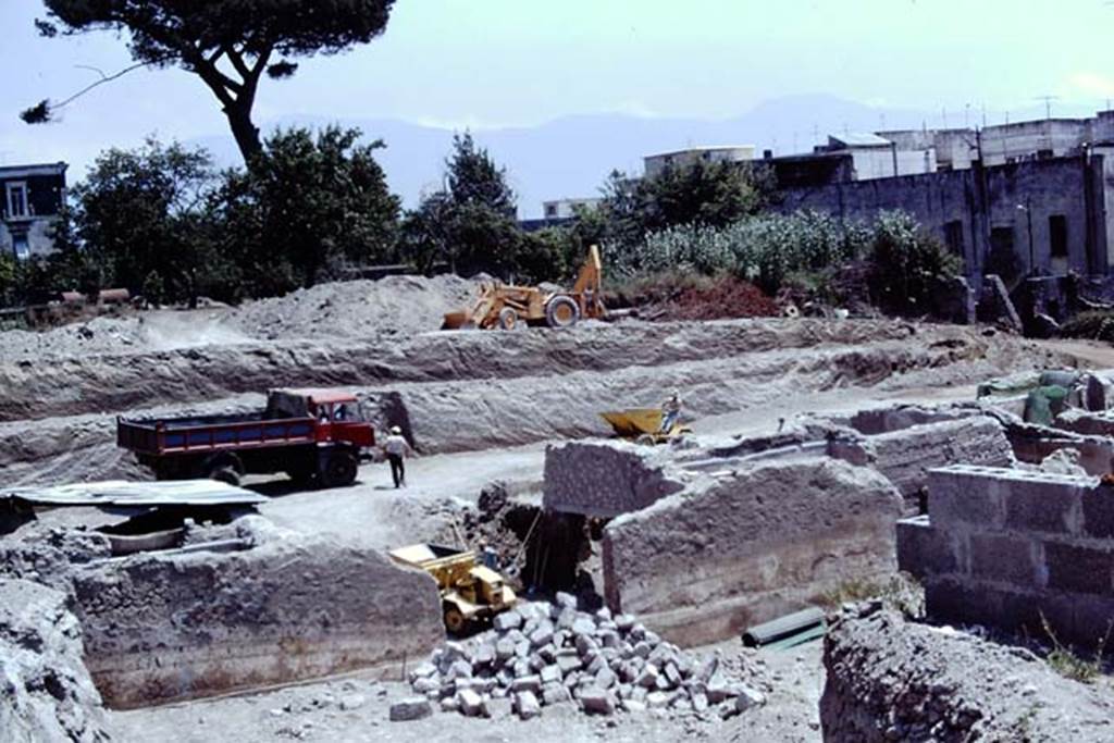 Oplontis Villa of Poppea, 1975 or 1974. Looking south-east across area of north garden towards room 69, (with yellow truck in it), which had a window onto the north garden in the wall this side, and opened on the far side onto the pool area 60. Photo by Stanley A. Jashemski.
Source: The Wilhelmina and Stanley A. Jashemski archive in the University of Maryland Library, Special Collections (See collection page) and made available under the Creative Commons Attribution-Non Commercial License v.4. See Licence and use details. J74f0871