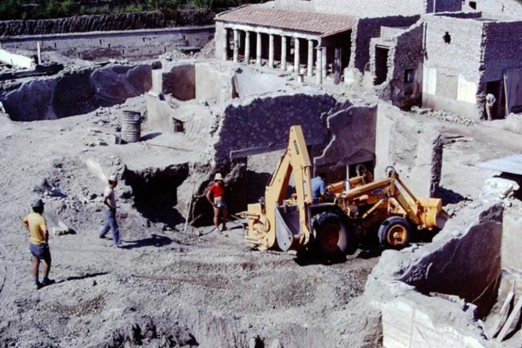 Oplontis, 1975. Looking south-west across room 69, with large yellow machinery.
The south-east peristyle, area 59, can be seen at the centre top. Photo by Stanley A. Jashemski.
Source: The Wilhelmina and Stanley A. Jashemski archive in the University of Maryland Library, Special Collections (See collection page) and made available under the Creative Commons Attribution-Non Commercial License v.4. See Licence and use details. J75f0023