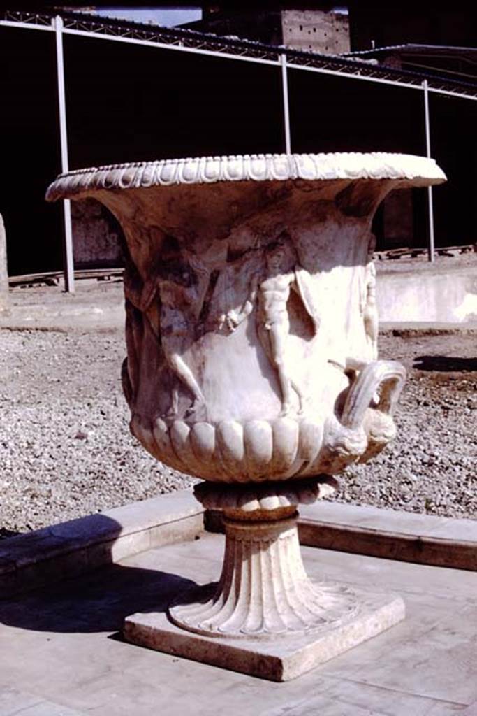 Oplontis, 1978. Large crater fountain vase positioned in the centre of the south side of the pool. Photo by Stanley A. Jashemski.
Source: The Wilhelmina and Stanley A. Jashemski archive in the University of Maryland Library, Special Collections (See collection page) and made available under the Creative Commons Attribution-Non Commercial License v.4. See Licence and use details. J78f0048
According to Wilhelmina, “We were delighted to see they had discovered the base of the beautiful marble crater fountain in a small pool in the garden area on the south side of the swimming pool where the crater had been originally located. We had admired the fountain on a previous trip, for it had been found earlier, in the rear portico of the villa where it had been stored, possibly after the earthquake.”
See Jashemski, W.F., 2014. Discovering the Gardens of Pompeii: Memoirs of a Garden Archaeologist, (p.263).
According to Wilhelmina, “the base of the large crater fountain was found in fragments in passage 53, where it had been stored at the time of the eruption”.
See Jashemski, W. F., 1993. The Gardens of Pompeii, Volume II: Appendices. New York: Caratzas. (p.298).