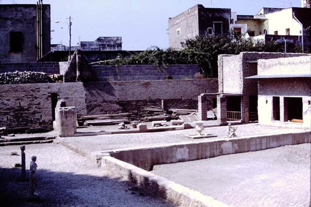 Oplontis, 1978. Area 92, looking south at east end of the pool.
A herm of Hercules and the statue of an ephebos are standing on their original bases.
Photo by Stanley A. Jashemski.
Source: The Wilhelmina and Stanley A. Jashemski archive in the University of Maryland Library, Special Collections (See collection page) and made available under the Creative Commons Attribution-Non Commercial License v.4. See Licence and use details.
J78f0057
