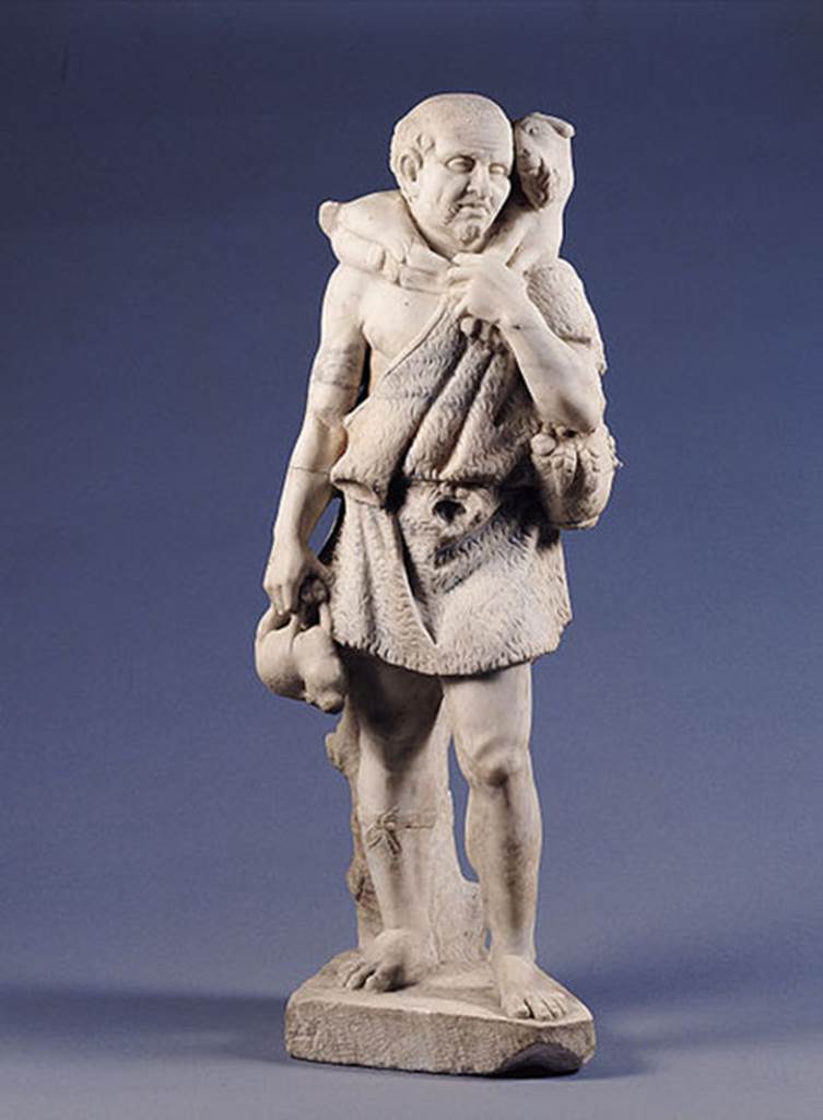 Castellamare di Stabia, Villa del Pastore. Statue of the shepherd.
According to Kockel, he is dressed in a belted Fellexomis ( a form of Greek tunic).
He carries a young goat on his shoulders, in his right hand he holds a hare.
He holds a basket with fruit and carries a backpack with a loaf of bread sticking out.
Garment, fruits and hair were coloured, but already are heavily faded.
See Kockel V., 1985. Funde und Forschungen in den Vesuvstadten 1: Archäologischer Anzeiger, Heft 3. 1985, p. 529ff, Abb. 11. 18. 23 Nr. 100.
Photo Wikimedia Commons, courtesy user Mentnafunangann..
This file is licensed under the Creative Commons Attribution-Share Alike 3.0 Unported.