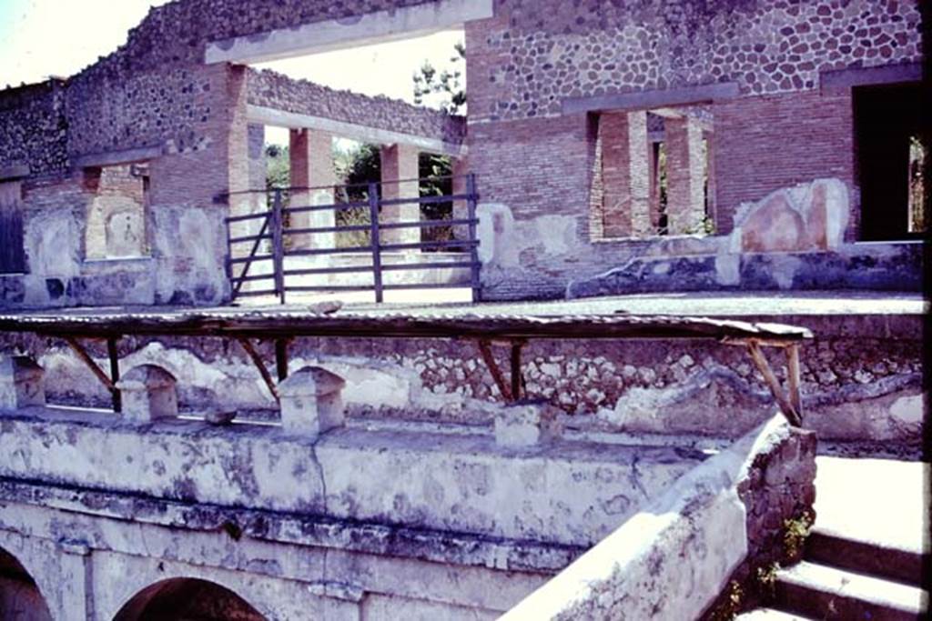 Villa Arianna, 1976. Looking towards the summer triclinium. In front of the fine rooms of the Villa, designed to take advantage of the view, was a portico but only one column remains from it, and a balustrade. On the right, at the side of the balustrade, the steps and a ramp would have led down to the two terraces and to the seashore. Photo by Stanley A. Jashemski.
Source: The Wilhelmina and Stanley A. Jashemski archive in the University of Maryland Library, Special Collections (See collection page) and made available under the Creative Commons Attribution-Non Commercial License v.4. See Licence and use details. J76f0517