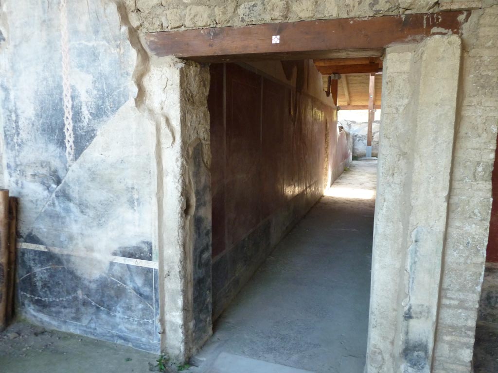 Stabiae, Villa Arianna, September 2015.
W.22, west portico of peristyle, looking west towards remains of painted decoration on south side of doorway to corridor W.27.