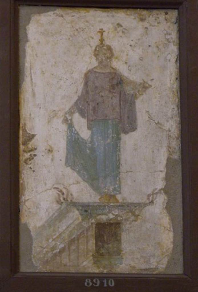 Stabiae, Villa Arianna, found 16th July 1759. Room W.24.
Wall painting of a caryatid wearing a green/blue and violet peplum (long Greek style dress, down to the ankles) and gold shoes.
She has her hair tied back and a candelabra in the form of a flower on her head.
She stands at the extremity of an architectural feature.
From upper wall of the same room as inventory number 8521.
Now in Naples Archaeological Museum. Inventory number 8910.
See Sampaolo V. and Bragantini I., Eds, 2009. La Pittura Pompeiana. Electa: Verona, p. 487.
See Pagano, M. and Prisciandaro, R., 2006. Studio sulle provenienze degli oggetti rinvenuti negli scavi borbonici del regno di Napoli. Naples: Nicola Longobardi, p. 243.