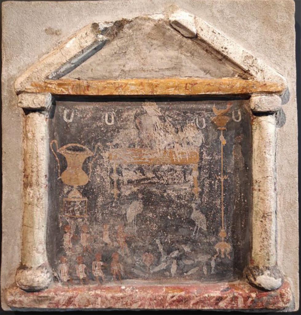 Stabiae, Villa Arianna, room 56. Stuccoed and painted lararium with an aedicula and two small columns supporting a pediment with marble painting.
According to Sodo, in the foreground are eight fishermen drawing in their nets full of fish. Behind is a golden couch with two wading birds aside it.
To the left is a silver kantharos and to the right a tall candelabra with a golden lamp.
Room 56 is situated on a ramp. It is a large room opening on to the bay and has no decoration preserved.
It is one of six rooms on the fourth floor of the villa ground level, preceded by a corridor and most likely used as storerooms or dwellings.
Now in Stabia Antiquarium, inventory number 69167.
See Otium Ludens, curated by Guzzo, P, Bonifacio, G, and Sodo, A.M. (2007). Castellammare di Stabia: Nicola Longobardi, p. 145.