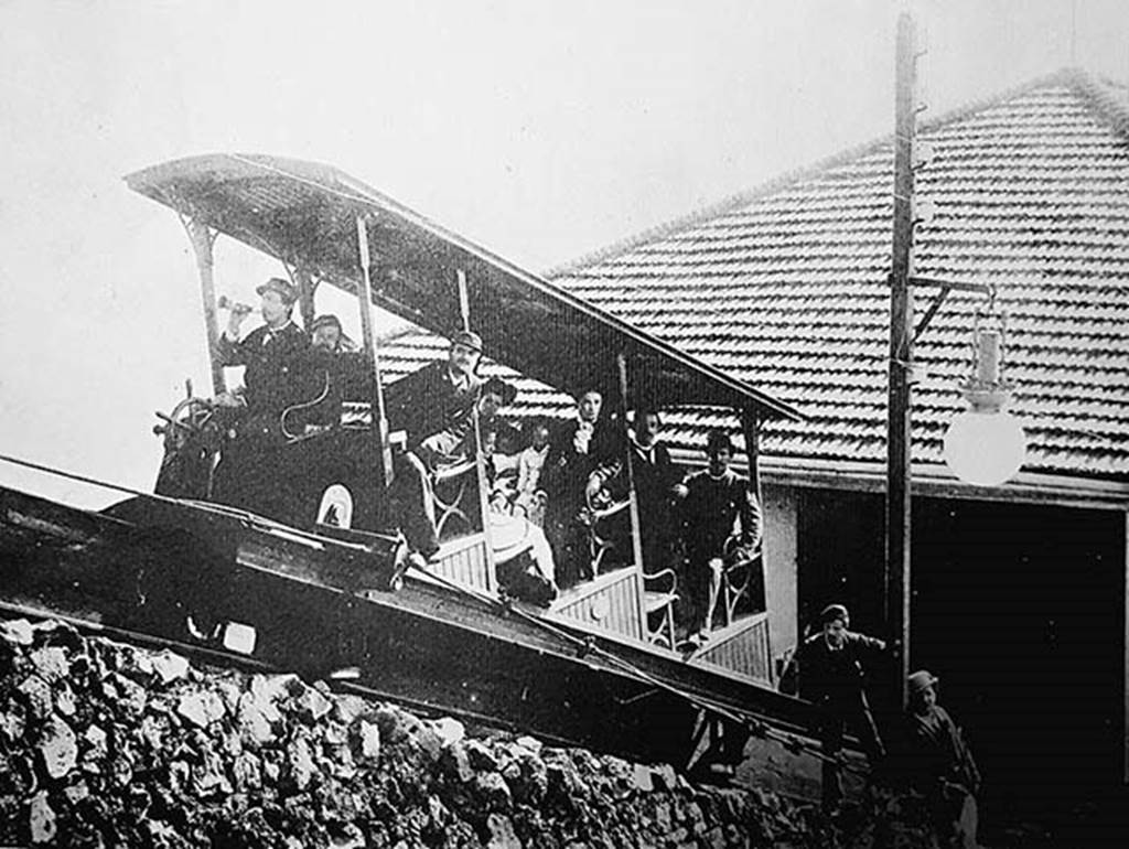 Vesuvius Funicular railway at the lower station c.1890.
Photo by Giorgio Sommer.
The winding house was at the bottom, where there were two 45 horsepower high pressure steam engines (one a reserve) and coal fired boilers.
The winding drum had automatic brakes to control the speed and the cars also had automatic brakes applied if the cable went slack.
As coal had to be brought up the mountain on horseback, this became an expensive item.