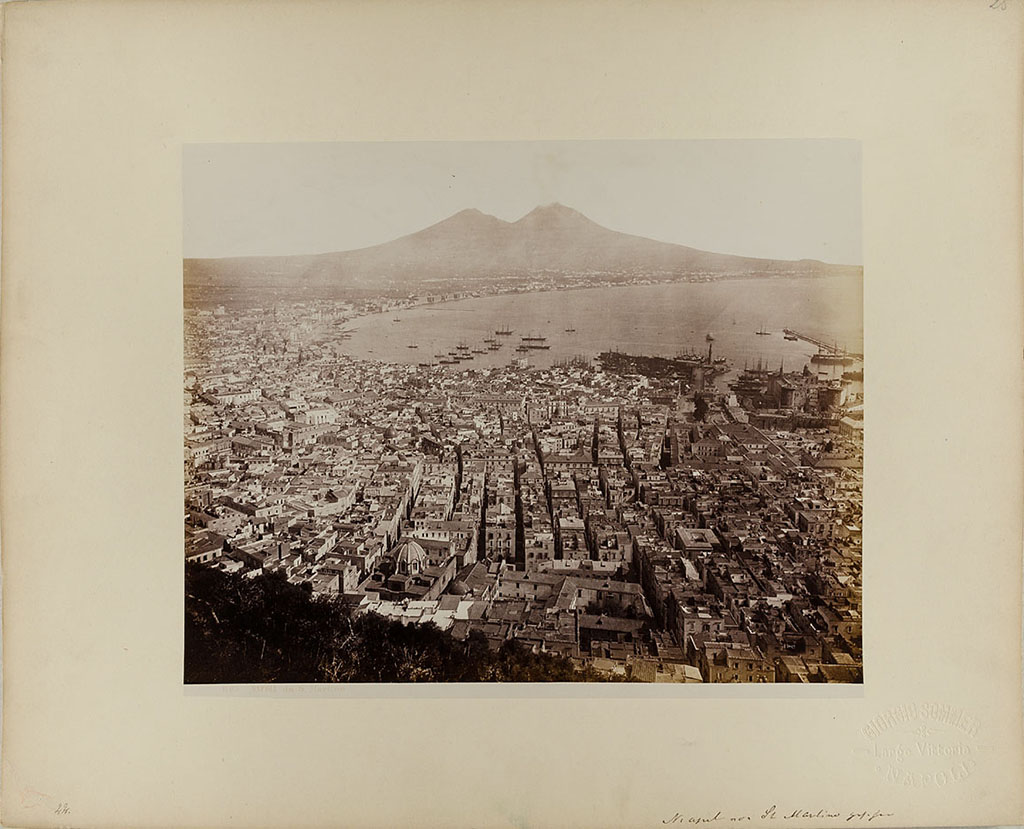 Vesuvius, 1860-1890. View of Naples from San Martino, with Vesuvius in the distance.
Photo title at bottom is “1103. NAPOLI da S. Martino” by G. Sommer Napoli.
The handwritten note says “Neapel von St Martino gesehen”.
Museum für Kunst und Gewerbe Hamburg, inventory number P1981.417 (Public Domain).
See https://sammlungonline.mkg-hamburg.de/de/object/1103.-Napoli-da-S.-Martino/P1981.417/mkg-e00135775