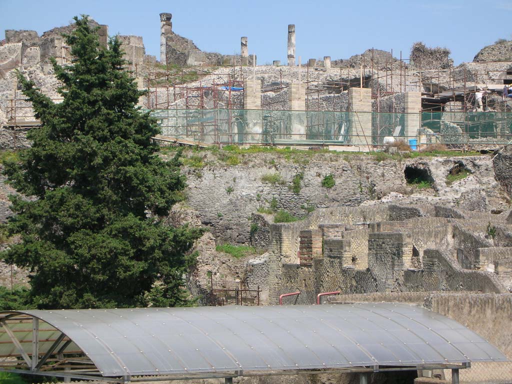 Walls on west side of Pompeii. May 2010.
Looking east to City Walls, below VII.16.15, and above roof of Suburban Baths. Photo courtesy of Ivo van der Graaff.